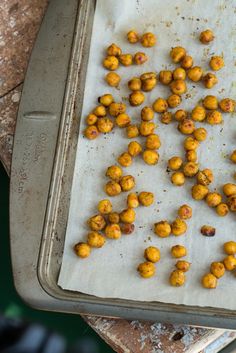 some food that is sitting on a baking sheet in the middle of an outdoor area