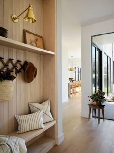 a room with wood paneling and shelves filled with hats, plants and other items