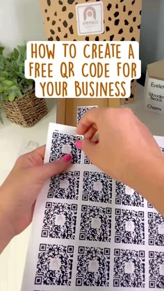 a person using a pen to create a qr code for their business