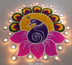 a colorful peacock is sitting on top of a flower with lit candles around it and the words happy diwali written below