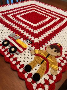 a crocheted tablecloth with an image of a fireman and his dog on it