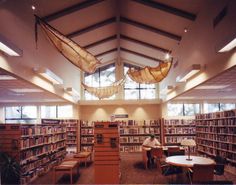 a library filled with lots of books and furniture