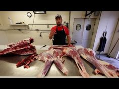 a man standing in front of some raw meat