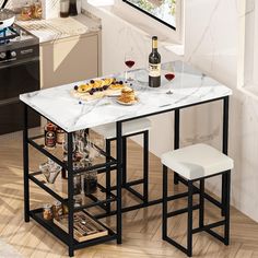 a kitchen table with two stools and a wine bottle on the counter next to it