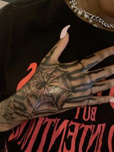 a person with tattoos on their arm and hand