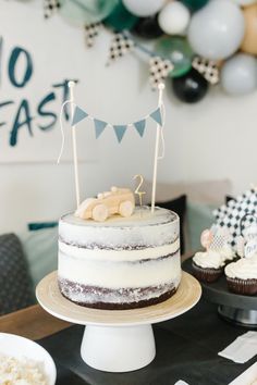 TWO FAST! a modern race car party for a boy's second birthday party. Featuring checkered race flags, wooden cars, a diy big balloon arch, and two fast banner. download your own custom invitation   cupcake toppers! Table decorated with Meri Meri race car plates, cups and napkins from A Little Confett Car 2nd Birthday Cake, Two Fast Birthday Party Cake, Two Fast Race Car Birthday, Birthday 2 Year Party, 2 Boy Birthday Party Ideas, Car Second Birthday Party, Modern Race Car Birthday Party, Simple 2nd Birthday Party Boys, Two Fast Birthday Cake Ideas