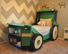 a child's bed made to look like a train car with wheels and tires