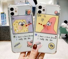 someone holding up two cell phones with cartoon pictures on them, one has a heart and the other has a nose