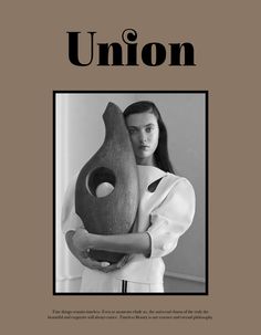 a woman holding a large vase in front of her face with the words union on it