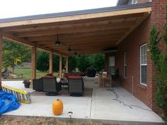 an outdoor covered patio with furniture on it