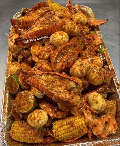 grilled shrimp and corn on the cob with barbecue sauce in a serving dish