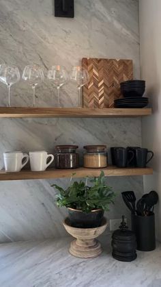 the shelves are filled with wine glasses, cups and other kitchen items on it's side