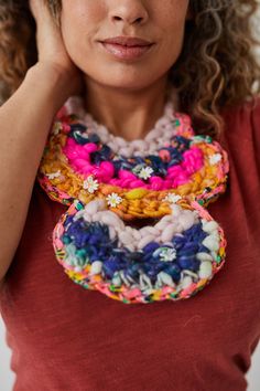 Introducing the Carmen Bib Necklace, Carmen Cuff, and Scrappy Loop Earring patterns by new-to-Knit Collage designer Lizz Hill Wiker. These crochet patterns are a great way to make wearable, statement accessories during the warmer seasons. All three pieces can be created in a single evening and make for the perfect stash buster for any special Knit Collage leftover yarn you may have. OR use one Mini Skein Sampler Kit as we've done in the photos shown here. Dress these pieces up with a breezy boho Earring Crochet, Designer Crochet, Knit Collage, Leftover Yarn, Jewelry Crochet, Yarn Flowers, Stash Buster, Cuff Earring, Lace Necklace