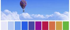 a colorful hot air balloon flying in the sky with clouds and blue sky behind it