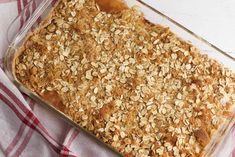 a casserole dish filled with oatmeal on top of a red and white checkered table cloth