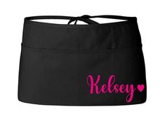 a black skirt with the word keley on it and hearts in pink ink,