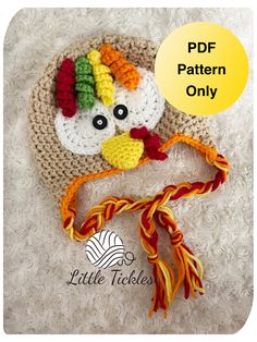 a crocheted hat with a turkey on it and a ribbon around the neck