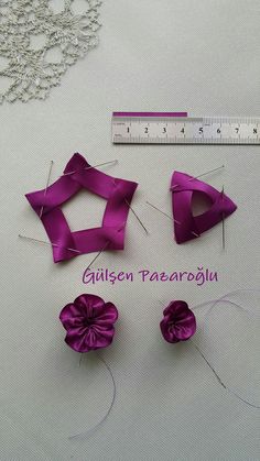 the sewing thread is being sewn together with purple ribbons and pins to make them look like bows