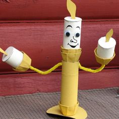 a paper mache character holding two cups