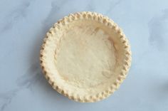 an uncooked pie crust sitting on top of a table