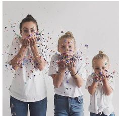 three girls with sprinkles on their faces and hands in front of them