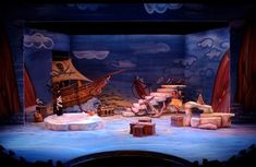 the stage is set for an animated show with animals and ships on it's sides