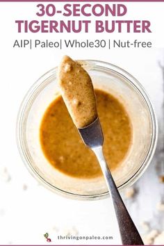 a spoon with peanut butter in it on top of a glass jar and the title 30 - second tigernut butter