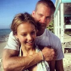 a man hugging a woman on the beach