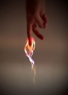 a hand reaching for something with flames coming out of it