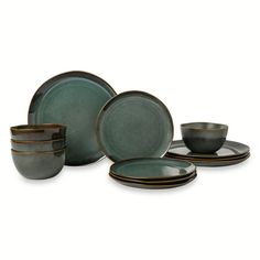 a set of green dishes and cups