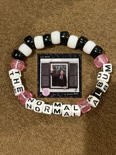 the beaded bracelet is decorated with words and pictures