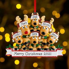 a christmas ornament with five reindeers hanging from it's sides and the words merry christmas written on them