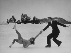 two people are playing in the snow with each other