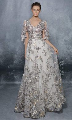 Graceful and dazzling, this beautifully themed gown by Tarik Ediz 96054 is a fashionable treat. Crafted with stunning embroidery of fluttering birds and florals, this inspired gown showcases a sheer capelet that shrouds the tailored bodice with V-neckline and flows over the arms and back. From the cinched natural waist, the luscious embroidered tulle skirt gracefully completes a full A-line floor-length hem creating a magical and trendy black-tie look. #eveningwear #formaldress #fancydress Tarik Ediz Dresses, Evening Dresses For Weddings, Cape Sleeves, Ladies Gown, Embroidery Dress, Formal Evening Dresses