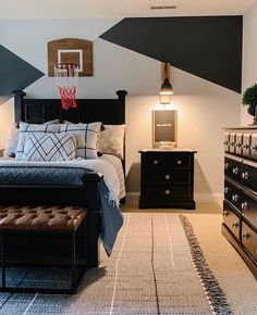 a bed room with a neatly made bed next to a dresser and a basketball hoop