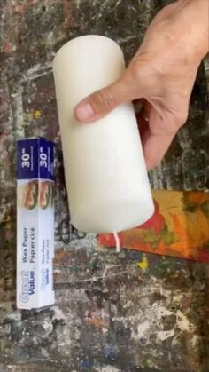 a person is holding a tube of white paint