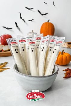 a bowl full of halloween candles with bats in the background