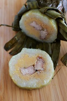 some food that is on top of a wooden table and has been cut in half