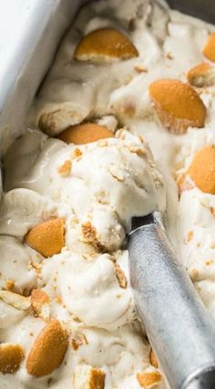 a scoop of ice cream in a pan with orange peels