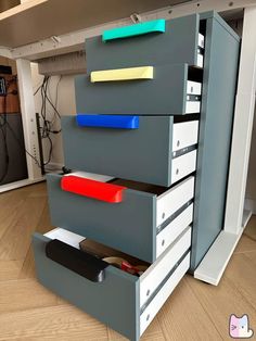 an office filing cabinet with five drawers and three file folders on the bottom drawer