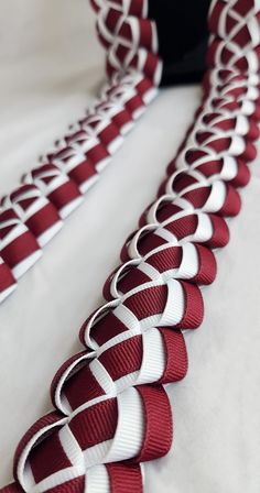 a red and white tie laying on top of a bed