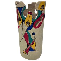 a vase with abstract designs painted on it's sides and bottom, sitting against a white background