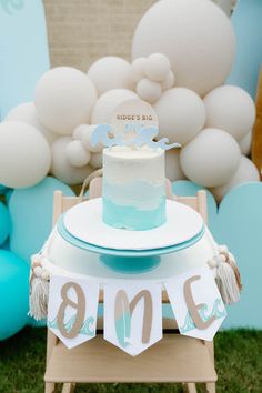 a blue and white cake sitting on top of a table