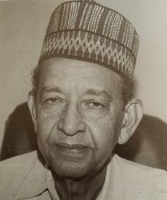 an old photo of a man wearing a hat