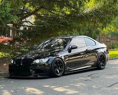 a black car is parked on the street