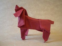 an origami dog made out of red paper