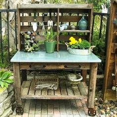 a potted plant sitting on top of a wooden shelf next to a garden bench