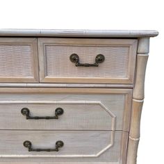 a white dresser with two drawers and handles