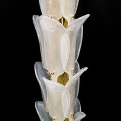 a tall glass vase with white flowers on it