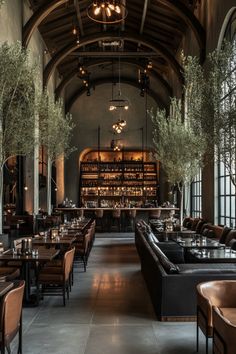 the interior of a restaurant with lots of tables and couches in front of large windows